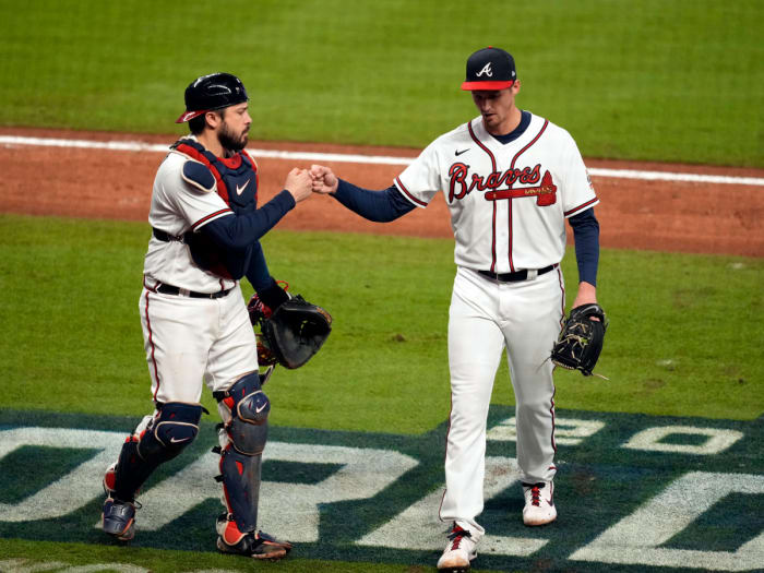 Oct 30, 2021; Atlanta, Georgia, USA; Atlanta Braves starting pitcher Kyle Wright (30) fist bumps catcher Travis d'Arnaud (16) after right gets out of the fifth inning of game four of the 2021 World Series against the Houston Astros at Truist Park.